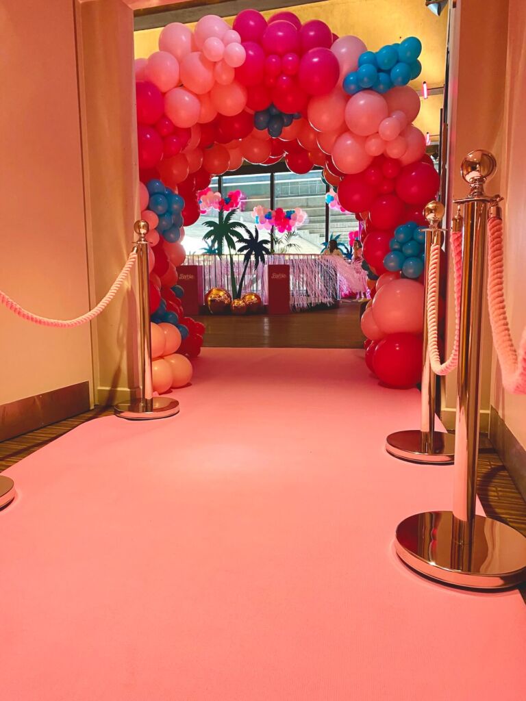 barbie balloon tunnel with pink carpet and pink stanchion rope