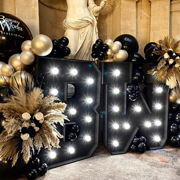 Corporate event at Marriott Royal Hotel Bristol featuring black and gold balloon display with illuminated letters by Every Last Detail